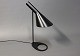 Black AJ table lamp, 1808, designed by Arne Jacobsen in 1960 and manufactured at Louis Poulsen.5000m2 showroom.