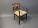 Armchair in polished mahogany decorated with inlaid fruitwood and upholstered in light fabric. 5000m2 showroom.