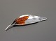 Brooch shaped as a leaf with a piece opf amber stamped Original Ulrich in 925 sterling silver.5000m2 showroom.